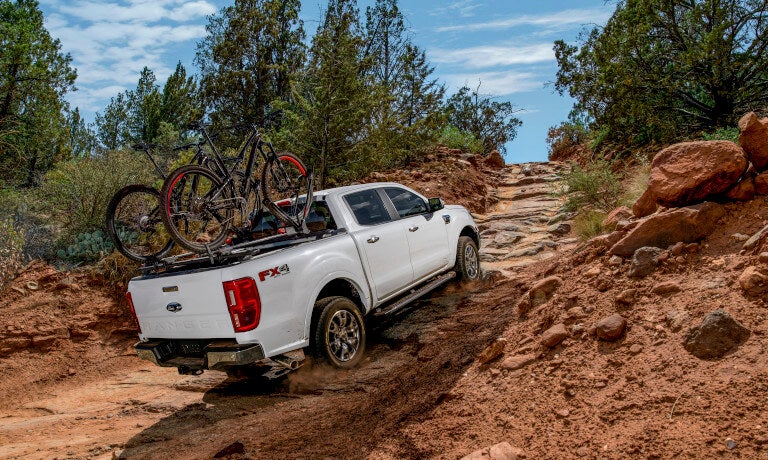 2023 Ford Ranger driving up rocky path with bikes