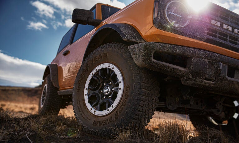 2024 Ford Bronco front wheel close up and covered in mud