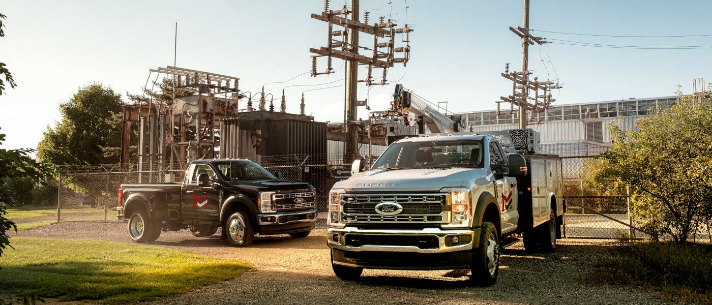 2026 Ford Super Duty pair parked by power plant